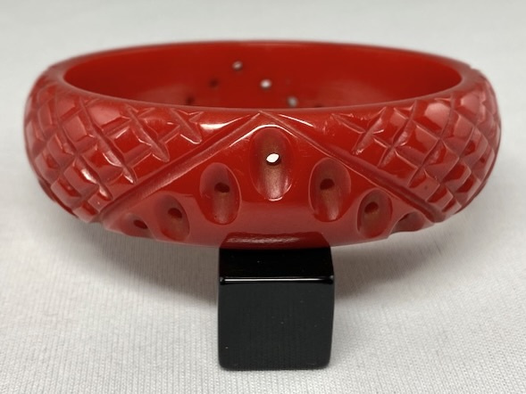 BB313 carved and pierced tomato red bakelite bangle